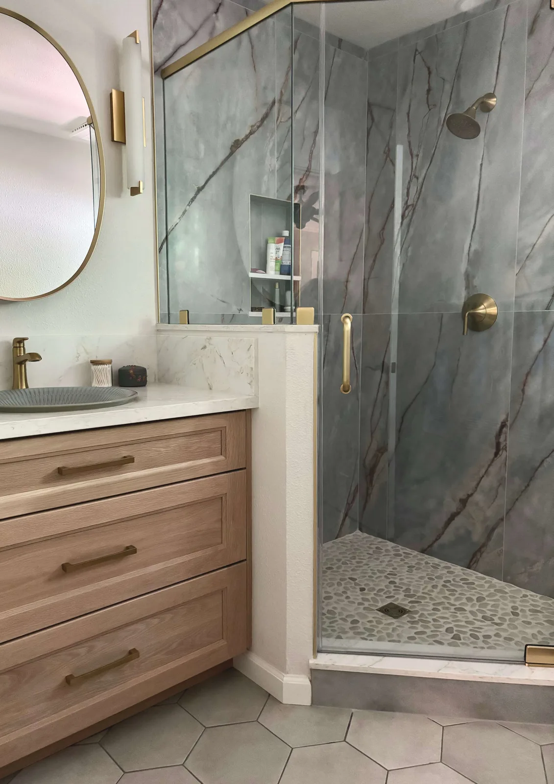 Bathroom remodel in River Park, Sacramento with marble-look shower surround and warm wood vanity by Designed Curated