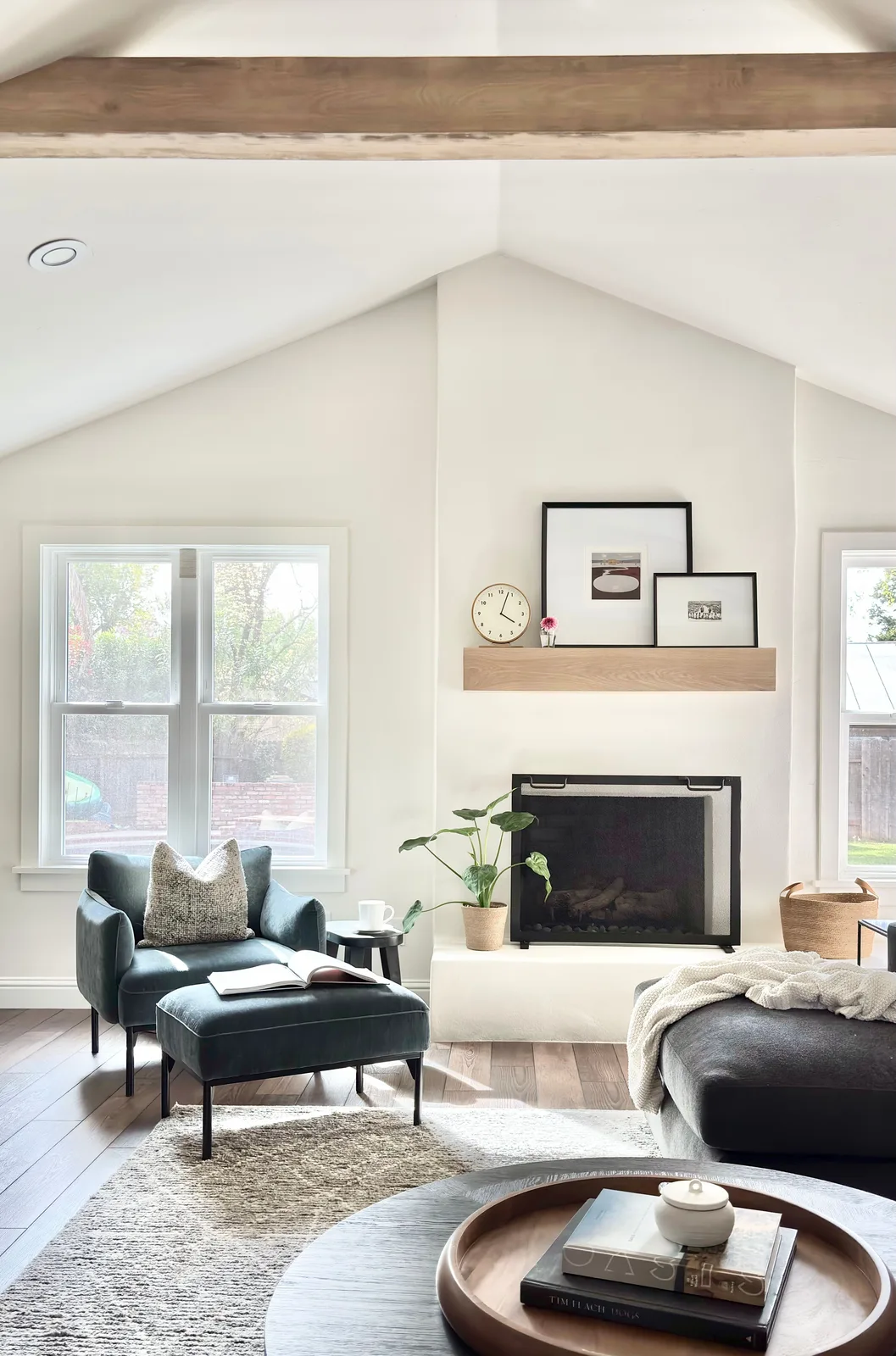 Living room in Sierra Oaks, Sacramento with fireplace, layered neutral textiles, and custom mantel styling by Designed Curated