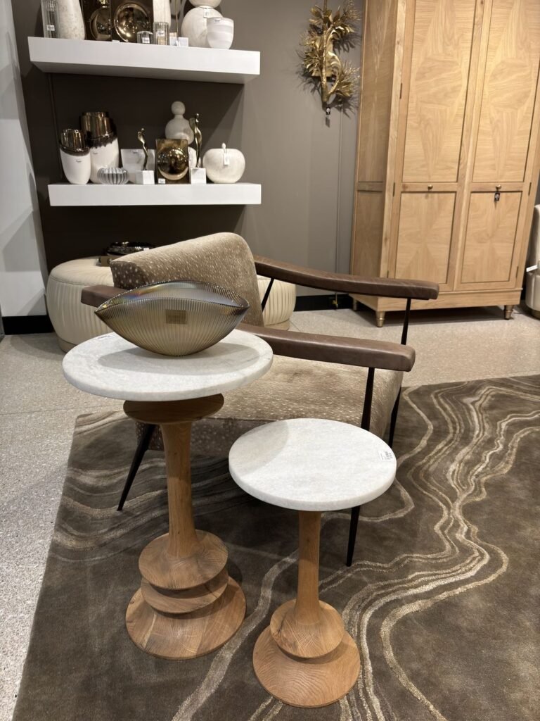 Modern interior design featuring a comfortable chair with a velvet upholstery, accompanied by minimalist circular side tables