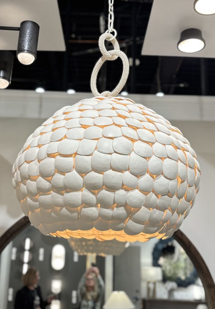 Contemporary pendant light fixture featuring a cloud-like design made of textured white discs, suspended by a decorative chai