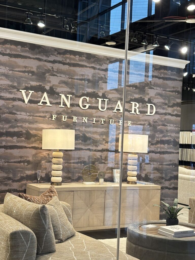 Modern interior display featuring a neutral color palette with textured wallpaper and minimalist furniture. The scene include