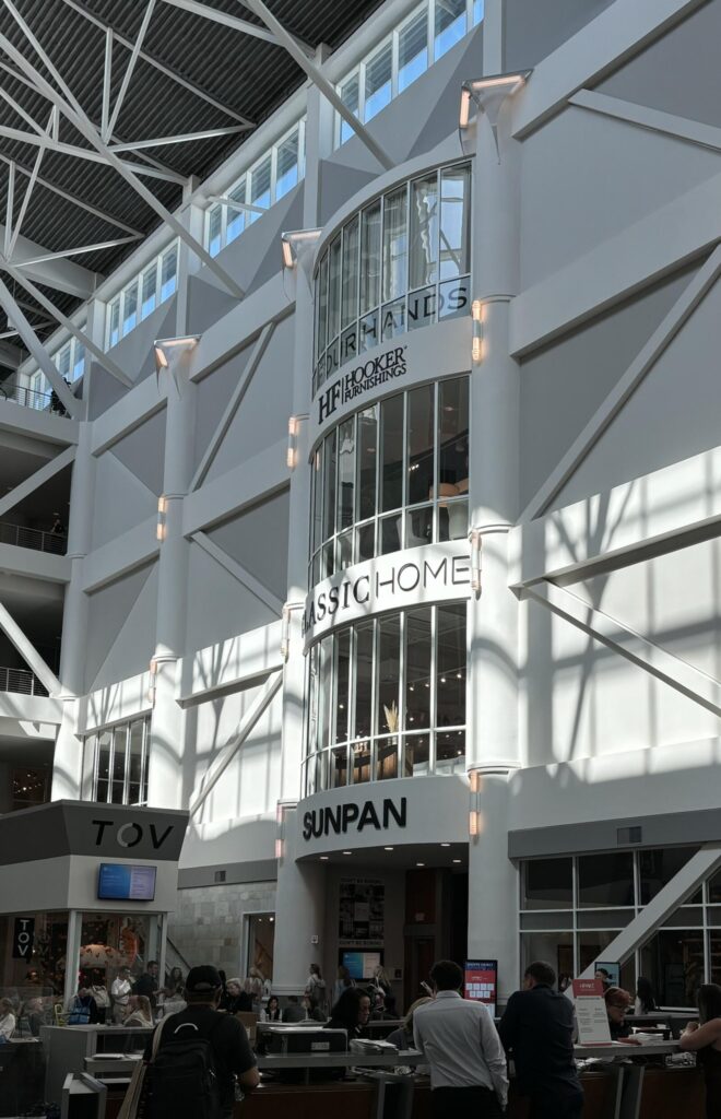 Modern indoor shopping mall with high ceilings, large glass windows, and open spaces featuring a contemporary design aestheti
