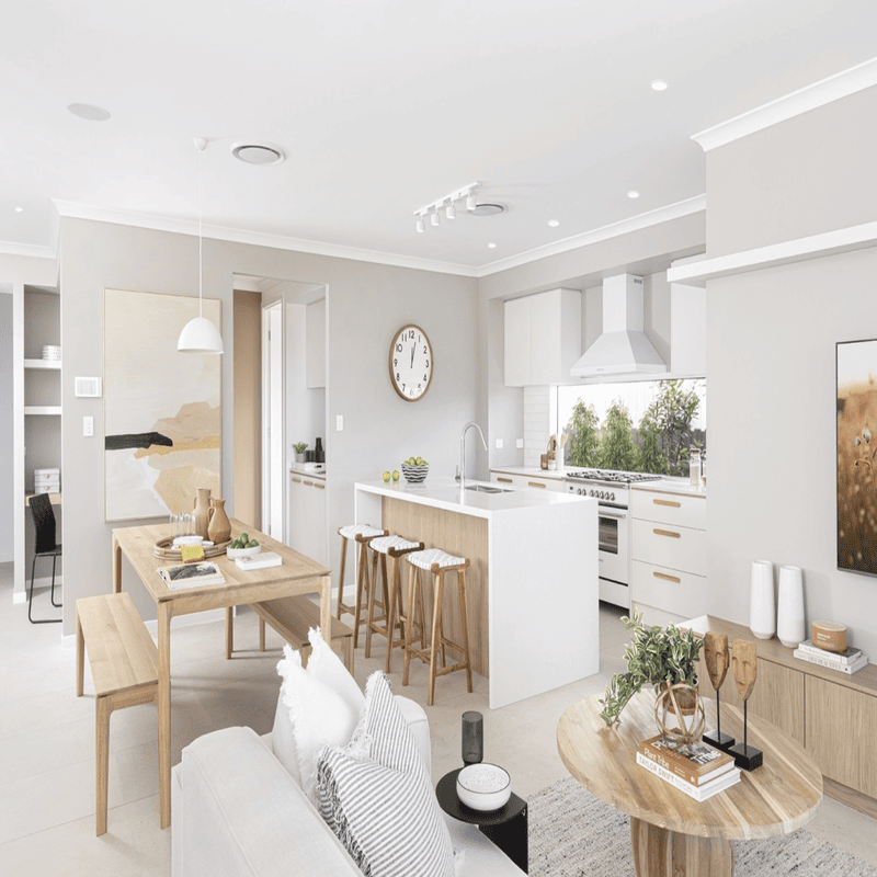 Modern open-concept kitchen and dining area with light wood furniture and neutral color palette, featuring a minimalist aesth