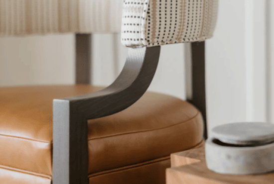 Contemporary interior detail featuring a leather seat with wooden legs and a patterned upholstered backrest, complemented by