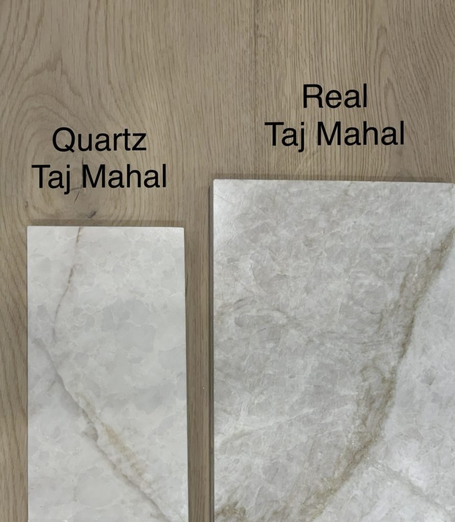 Close-up of two types of stone countertop samples, one labeled 'Quartz Taj Mahal' and the other 'Real Taj Mahal', showcasing