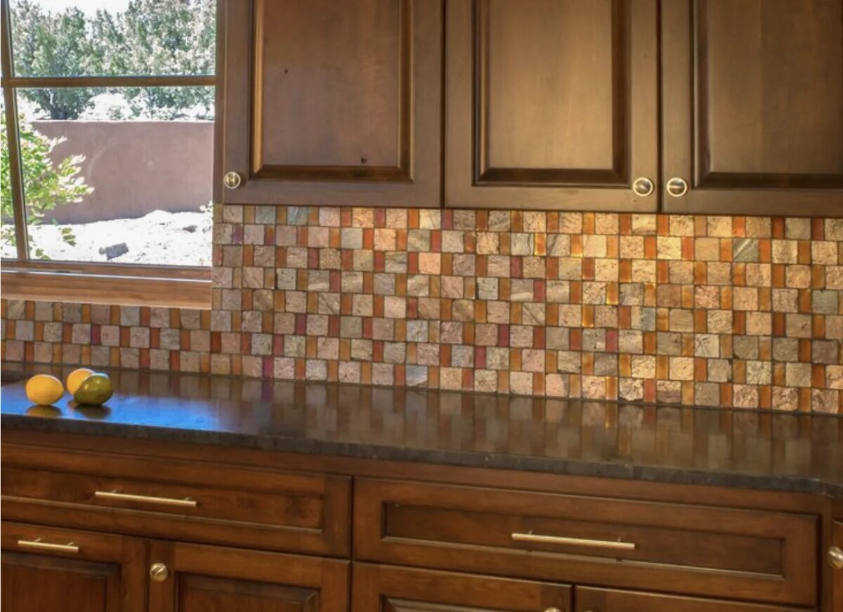 Copper-tile kitchen backsplash &mdash; one of the defining 2023 designer-spec materials