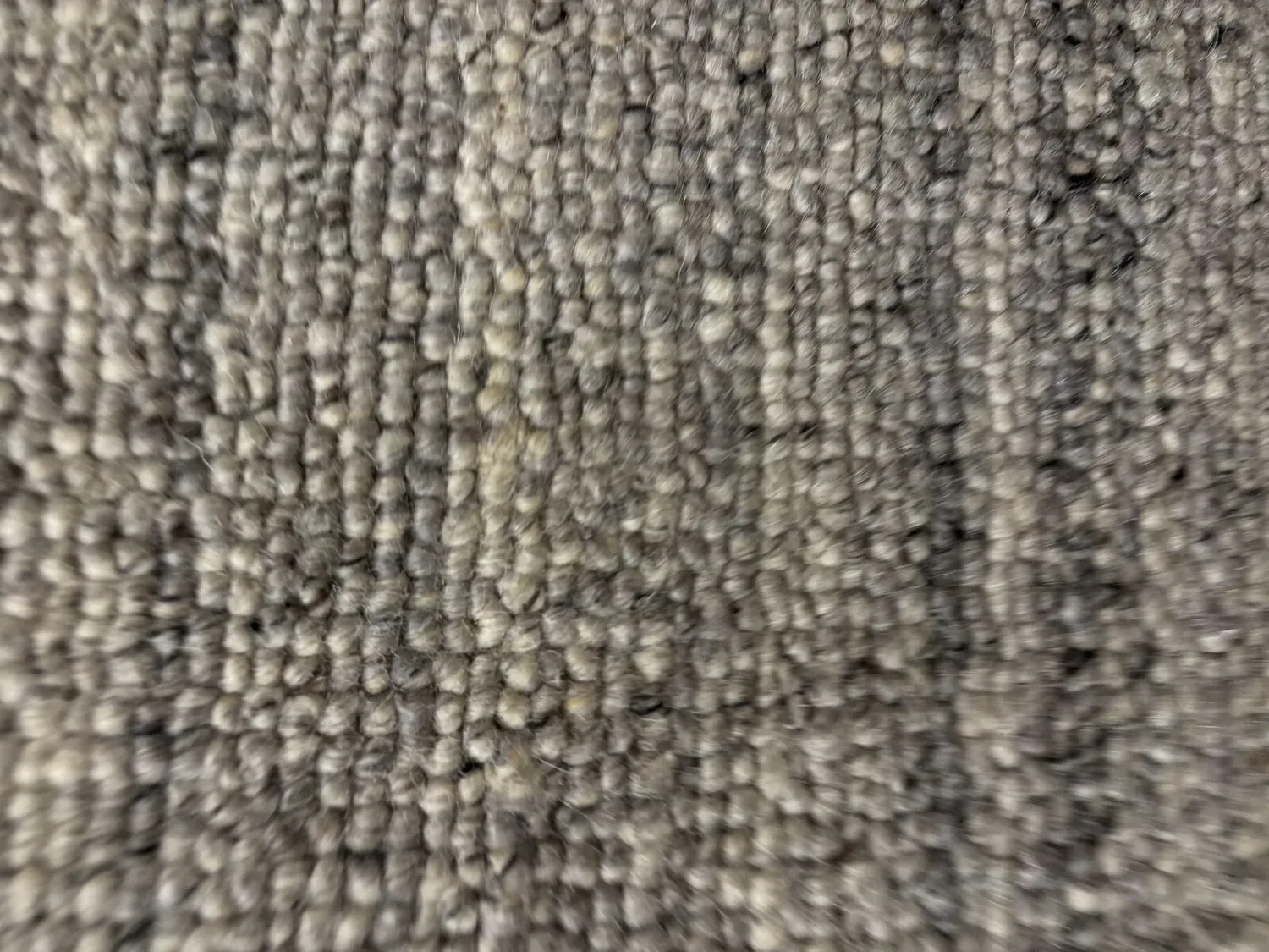 Close-up image of a textured gray carpet or rug