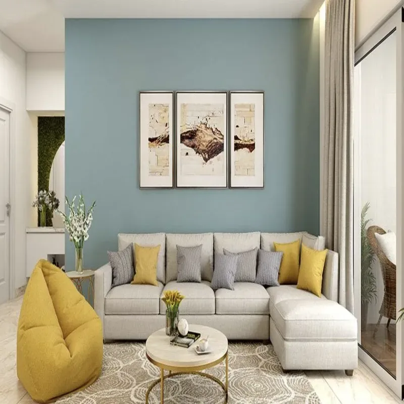 A modern living room with a light gray sectional sofa, yellow and gray pillows, a yellow bean bag chair, a round coffee