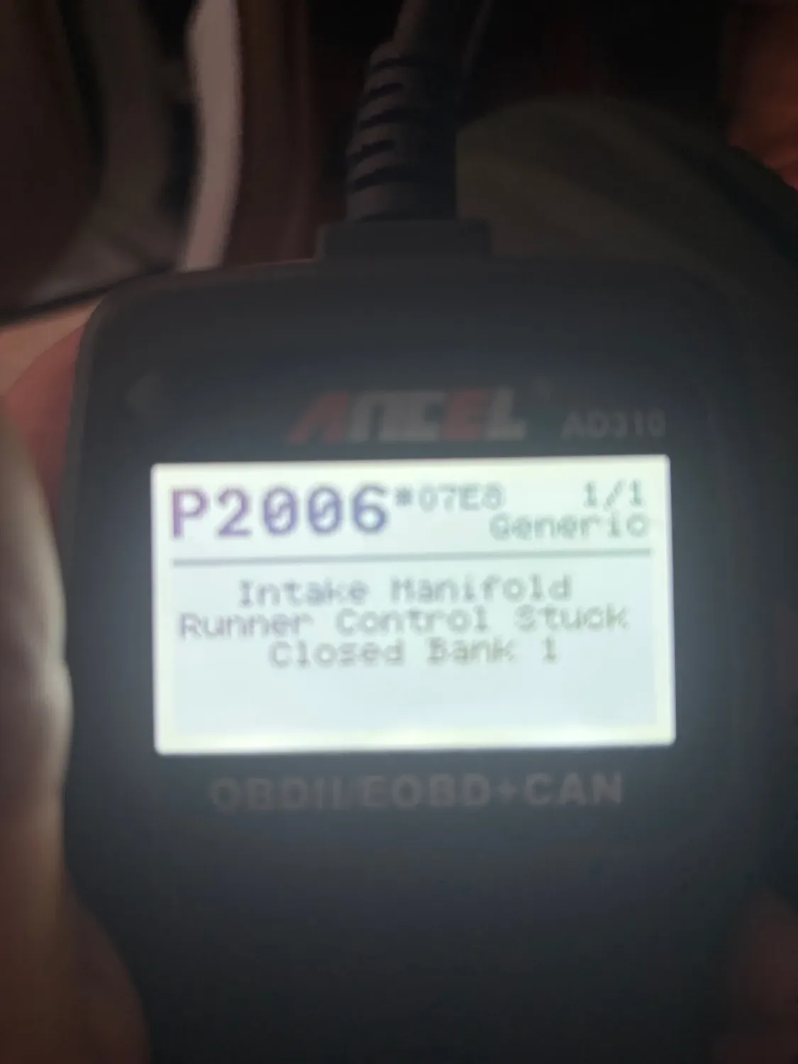 Close-up of an Autel AD310 OBDII/EOBD+CAN diagnostic tool displaying a P2006 error code related to the intake manifold runner control