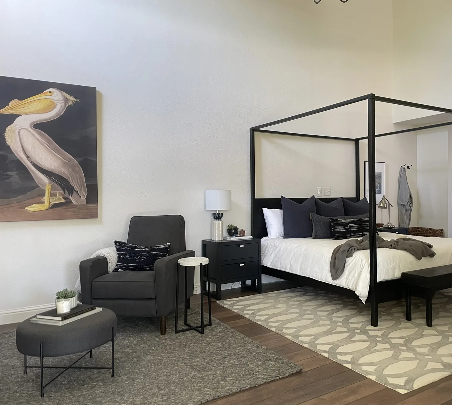 A neatly arranged bedroom with a wooden bed, matching nightstands, a dresser, and soft natural lighting