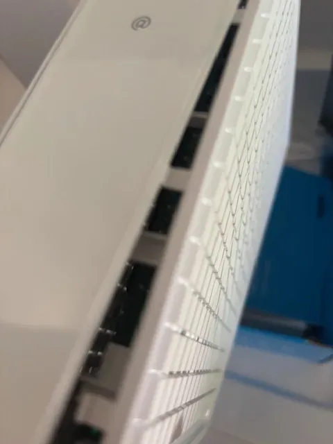 Close-up angled view of a white computer keyboard with a blurred background