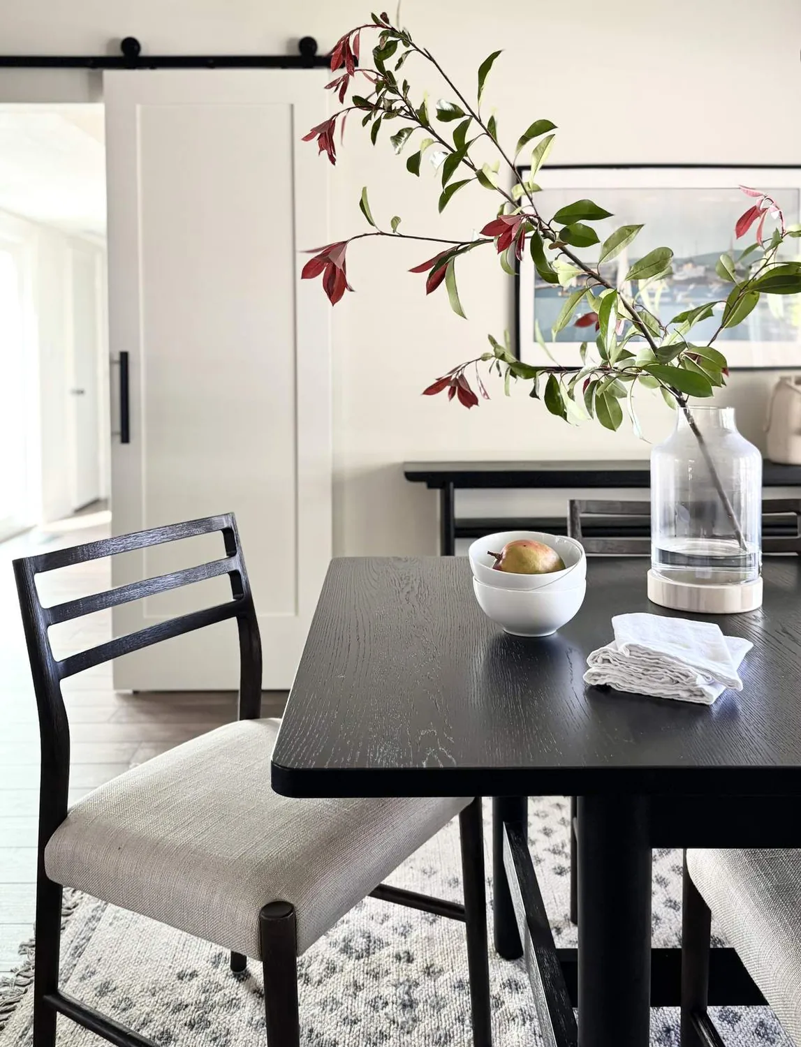 A flat lay of various interior design samples and decorative objects arranged in a clear tray