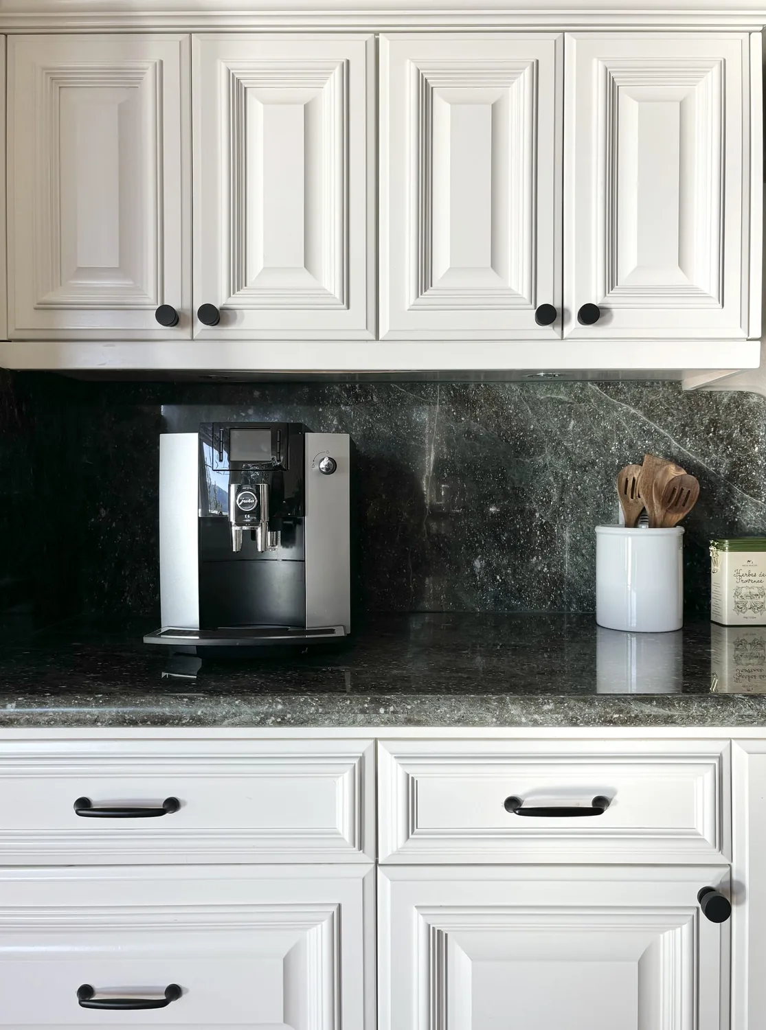 A navy kitchen island under exposed beams
