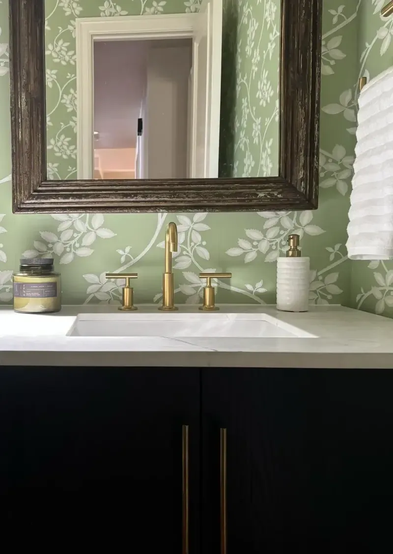 Beige walls, corner toilet. Above hangs a Van Gogh print