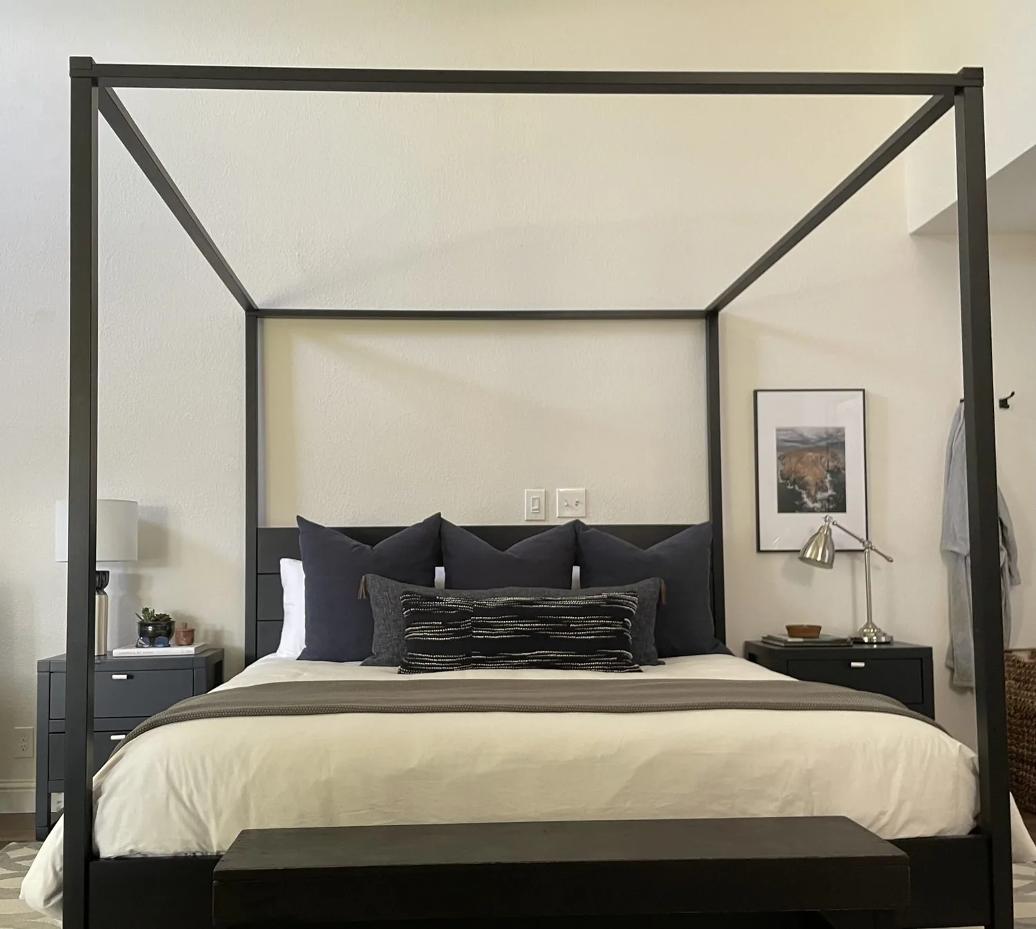 Think of a room with wood beams, a big bed, maybe a navy chair. Neutral walls