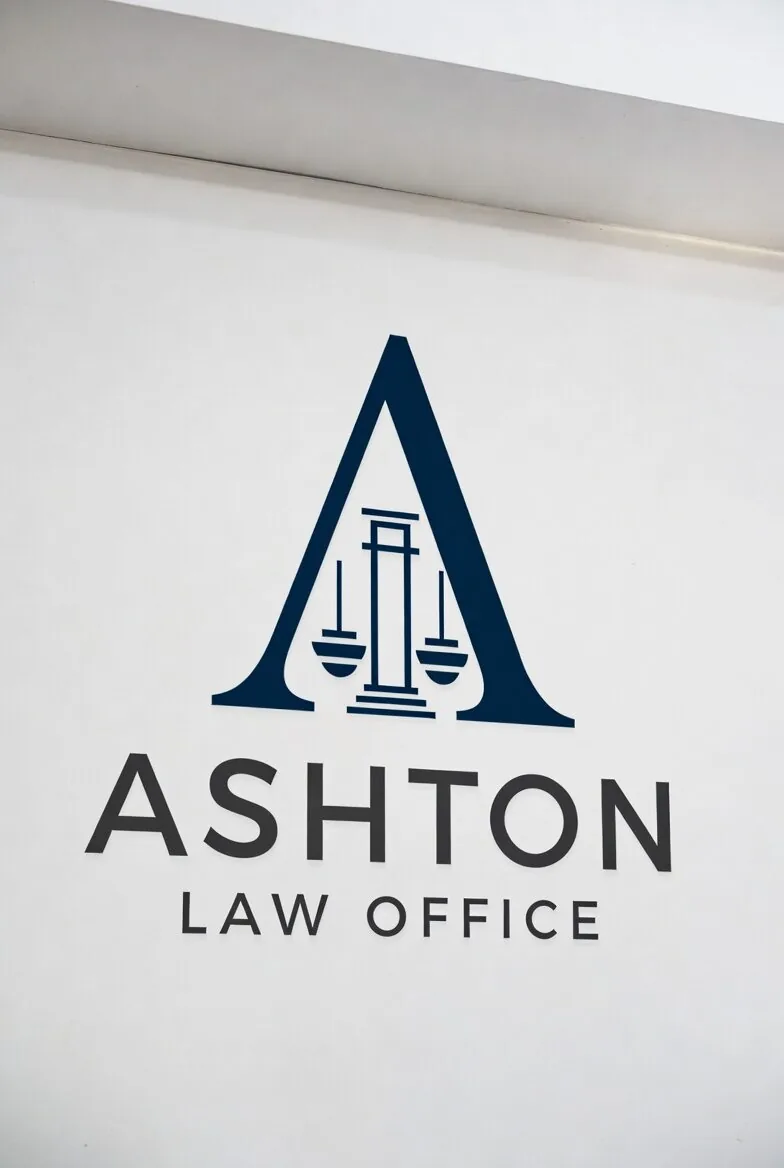 A wall sign for Ashton Law Office featuring a large stylized letter A with scales of justice inside
